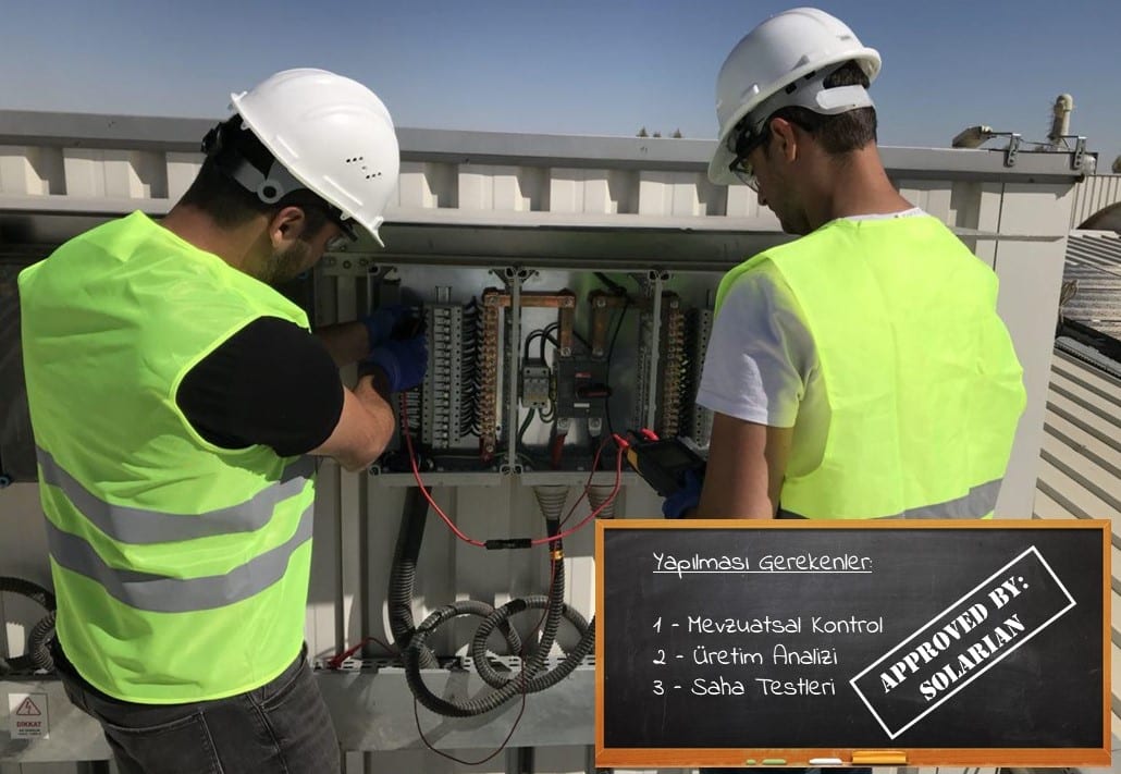 İki teknisyen elektrik pano kutusunda ölçüm yapıyor, yanında yapılması gerekenleri listeleyen bir kara tahta grafiği